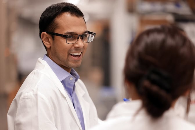 Joshua Jack working with a student in the George G. Brown Laboratories.